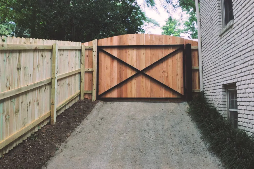 Cedar double drive gate in a wood privacy fence